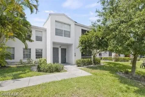 View of front of property featuring a front lawn and stucco siding