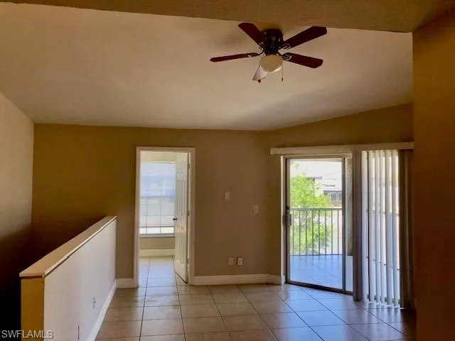 Spare room with a ceiling fan and light tile patterned flooring