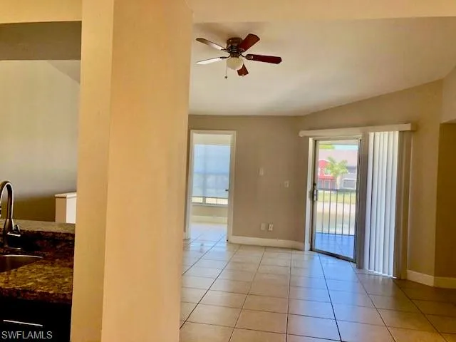 Unfurnished room featuring a ceiling fan and light tile patterned floors