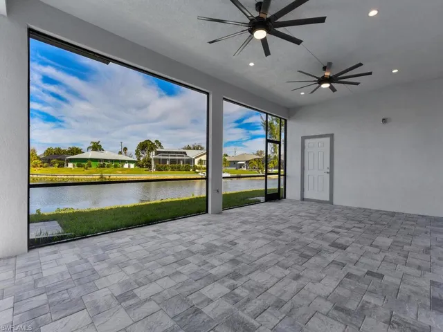Unfurnished sunroom with a water view and ceiling fan