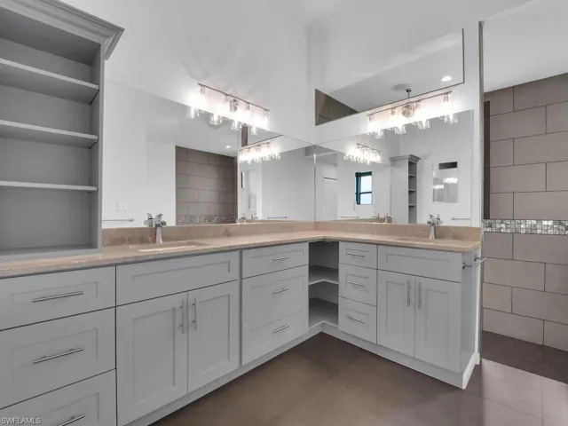 Full bathroom featuring tile walls and vanity