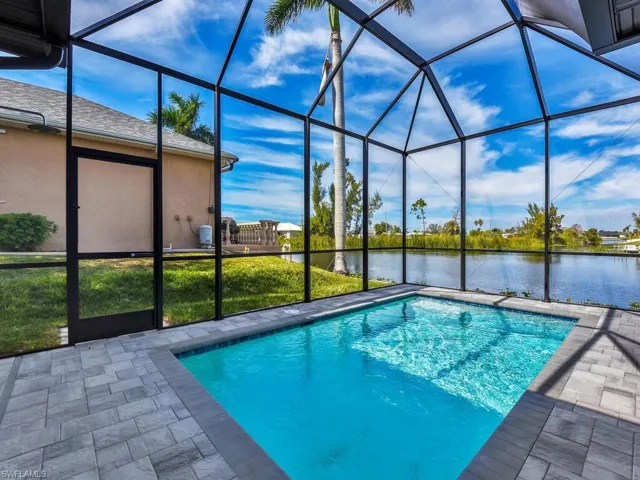 Pool with a water view, a lanai, and a patio area