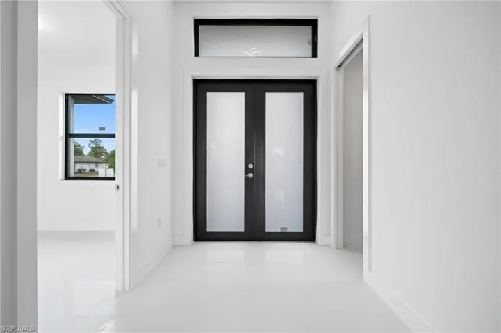 Foyer entrance featuring french doors and baseboards