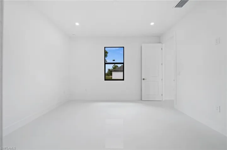 Empty room featuring recessed lighting