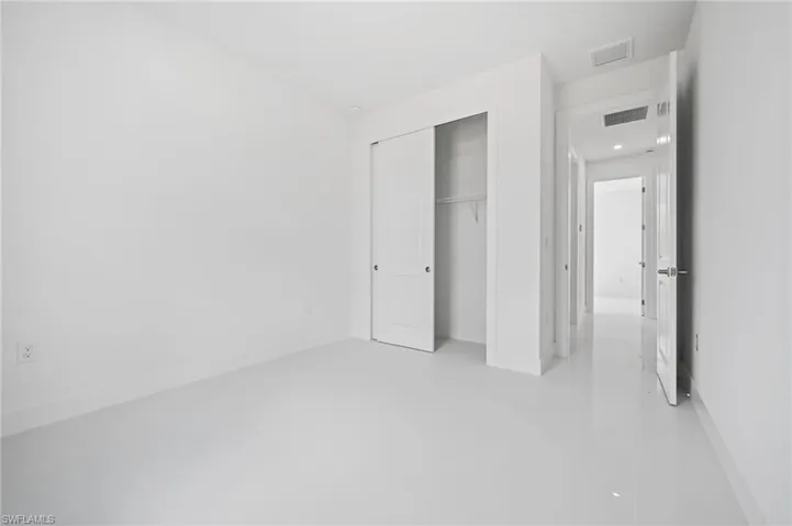 Unfurnished bedroom featuring a closet and light tile patterned flooring