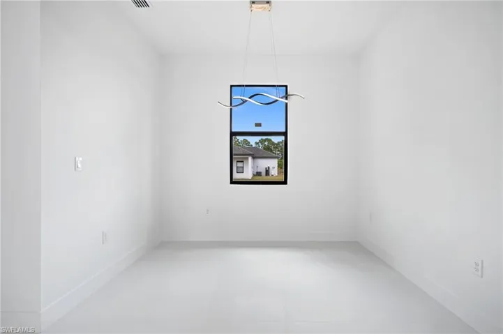 Unfurnished room featuring baseboards
