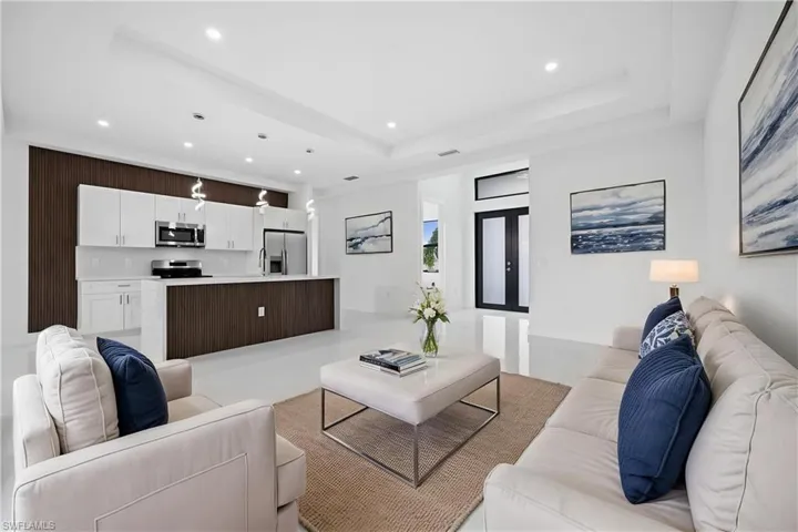 Living area featuring recessed lighting and concrete floors
