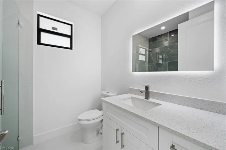 Bathroom featuring vanity and a shower stall