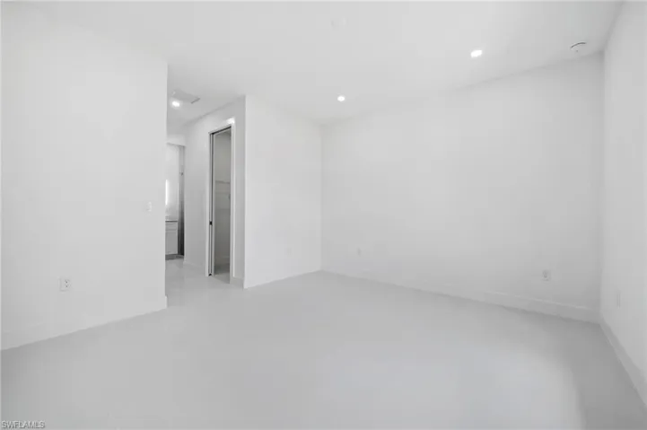 Empty room with baseboards and recessed lighting