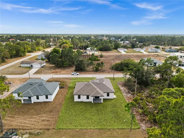 Aerial perspective of suburban area featuring a tree filled landscape