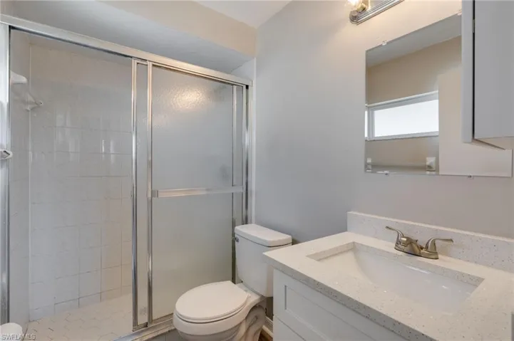 Bathroom with vanity and a stall shower