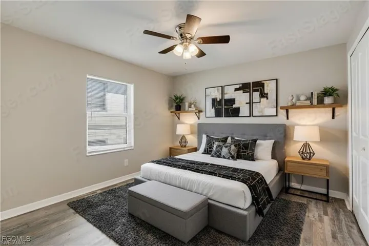 Bedroom with light wood-type flooring, a closet, and ceiling fan