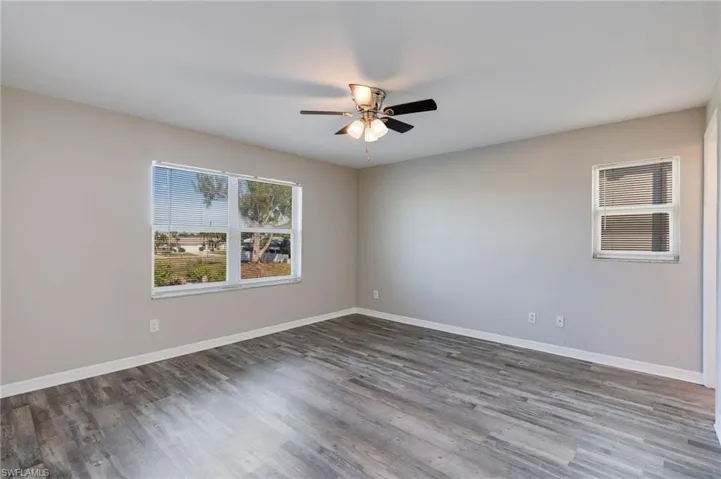 Unfurnished room featuring wood finished floors and a ceiling fan