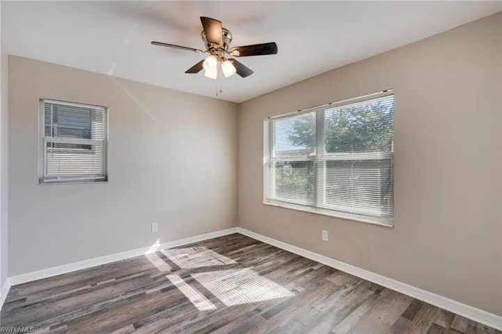 Empty room with wood finished floors and ceiling fan