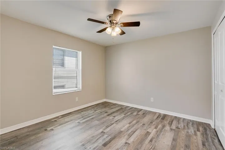 Unfurnished bedroom with a closet, light wood-type flooring, and ceiling fan