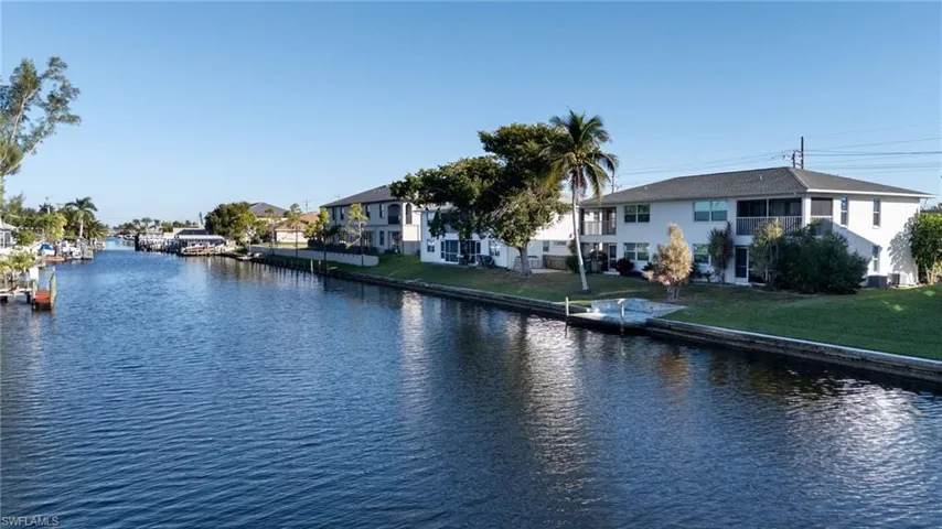 Water view with nearby suburban area and a boat dock