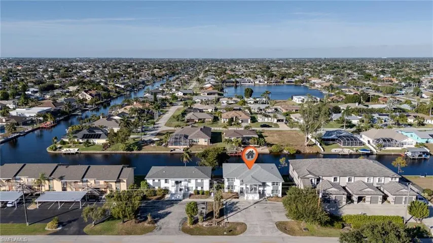 Aerial perspective of suburban area featuring a large body of water