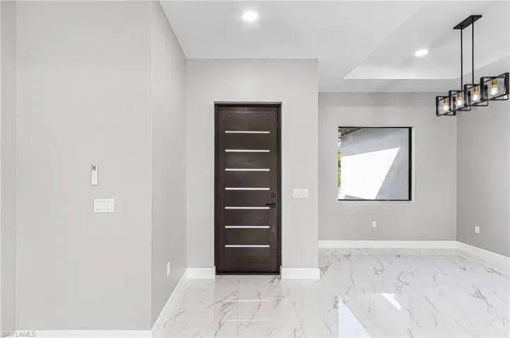 Entryway with baseboards and recessed lighting