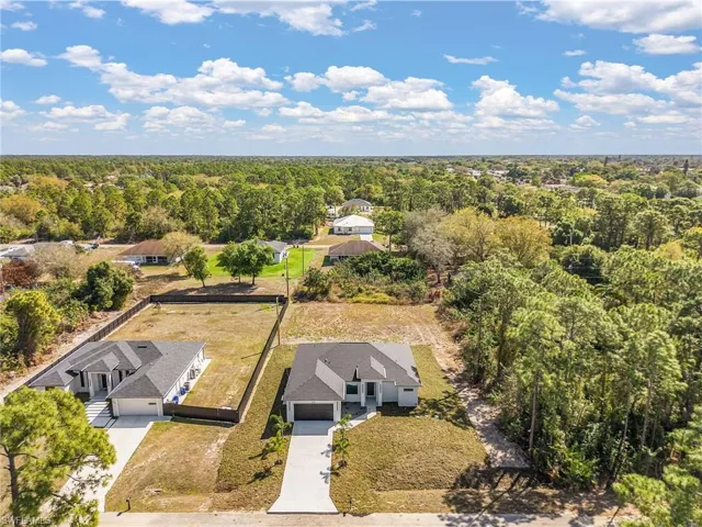 Aerial view of residential area featuring a heavily wooded area