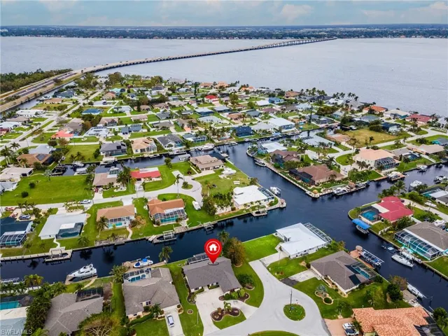 Aerial view of residential area with a nearby body of water and a notable bridge