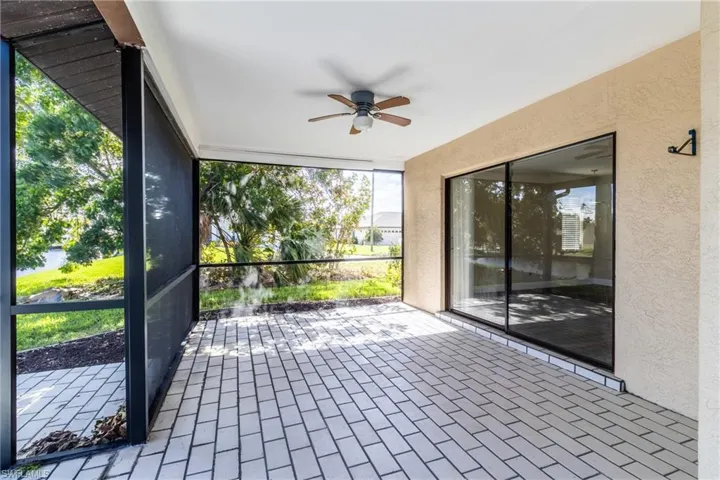 Unfurnished sunroom featuring ceiling fan and healthy amount of natural light