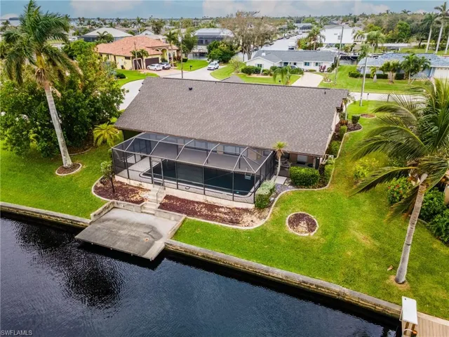 Aerial view of residential area featuring a nearby body of water