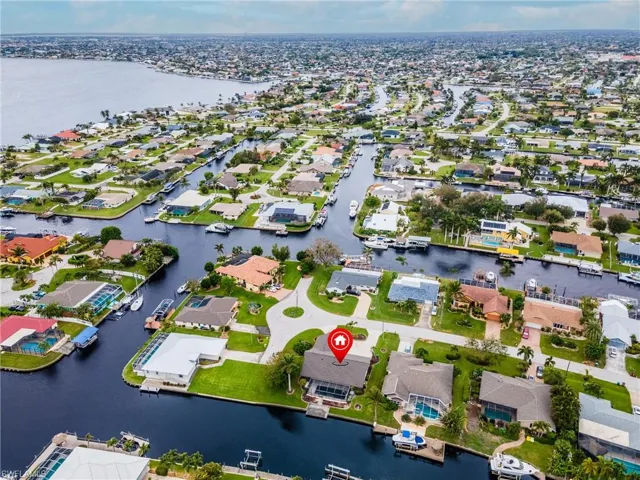 Aerial view of property's location featuring a large body of water and nearby suburban area