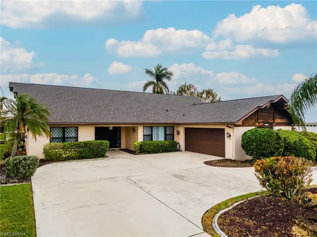 Single story home featuring roof with shingles, stucco siding, concrete driveway, and an attached garage