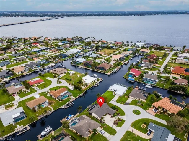 Aerial perspective of suburban area featuring a nearby body of water
