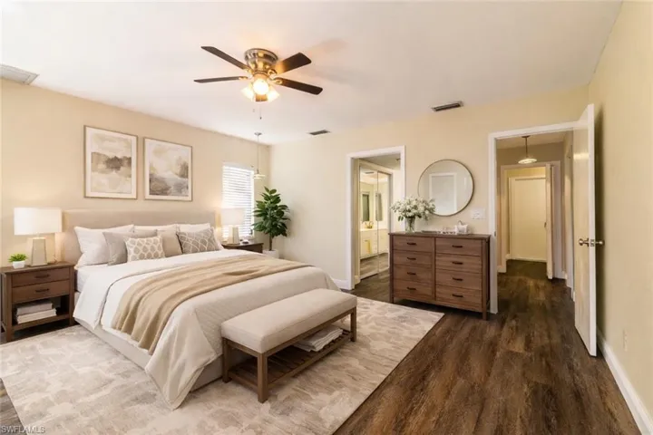 VIRTUALLY STAGED! Bedroom with dark wood-style flooring, a ceiling fan, and ensuite bathroom