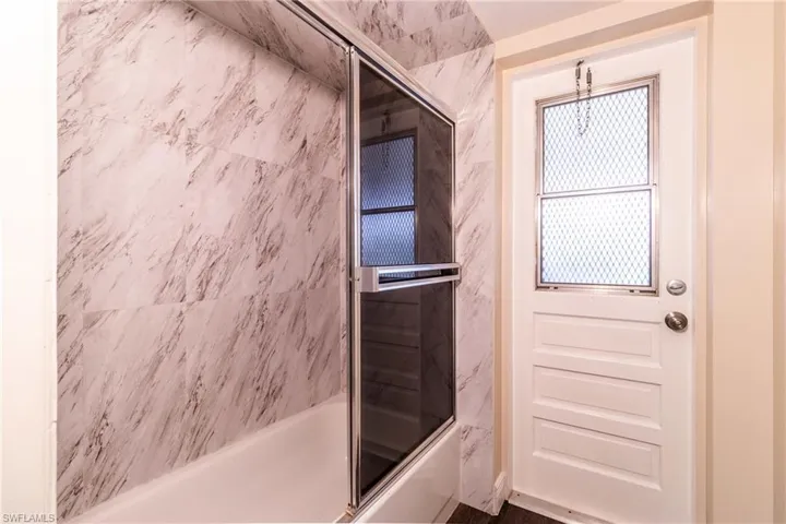 Full bathroom with enclosed tub / shower combo