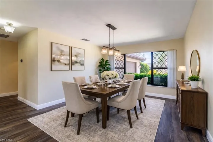 VIRTUALLY STAGED! Dining area with dark wood-type flooring