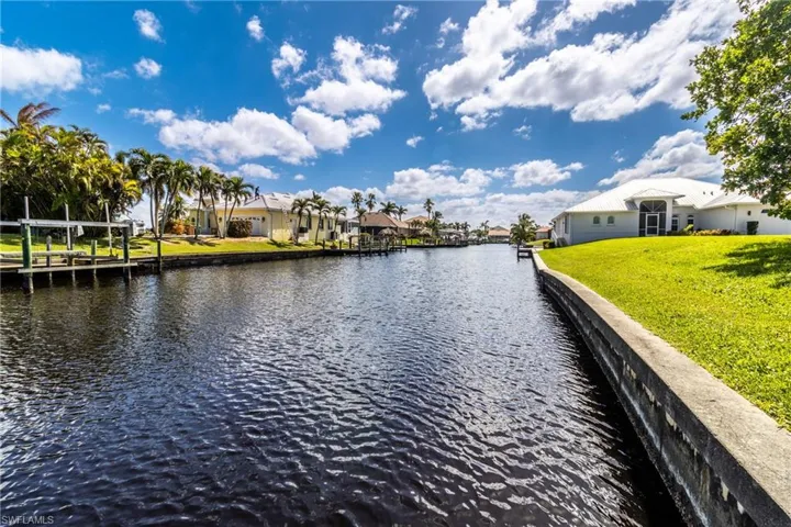 Dock featuring a water view, a residential view, and a yard