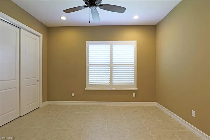Unfurnished bedroom with a closet, recessed lighting, ceiling fan, and light tile patterned floors