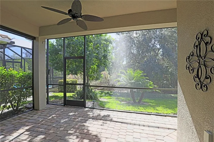 Unfurnished sunroom featuring ceiling fan