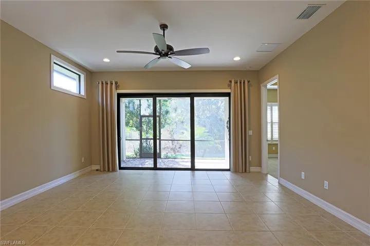 Empty room featuring a ceiling fan, light tile patterned floors, and recessed lighting