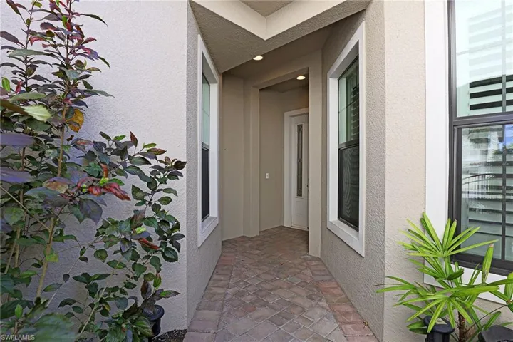 Property entrance featuring stucco siding