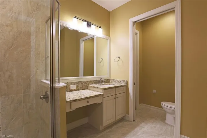 Bathroom featuring a stall shower and vanity