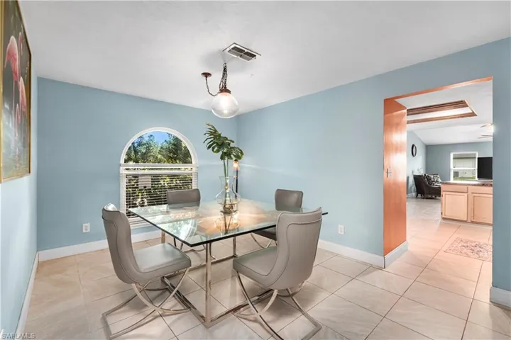Dining room featuring light tile patterned floors and baseboards