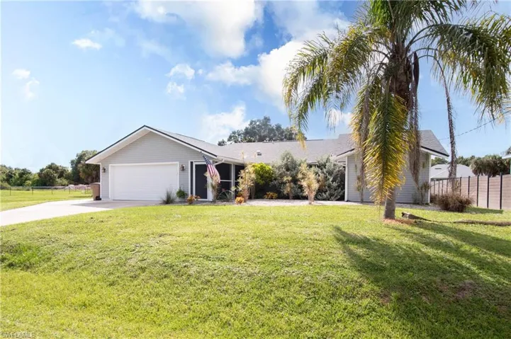 Ranch-style house with concrete driveway and a garage