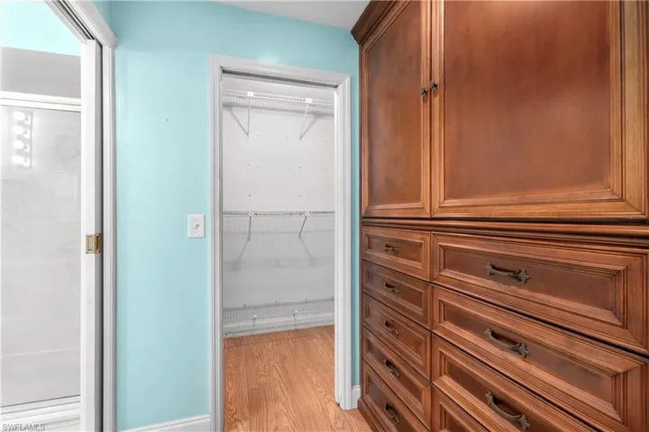 Walk in closet featuring light wood-style floors