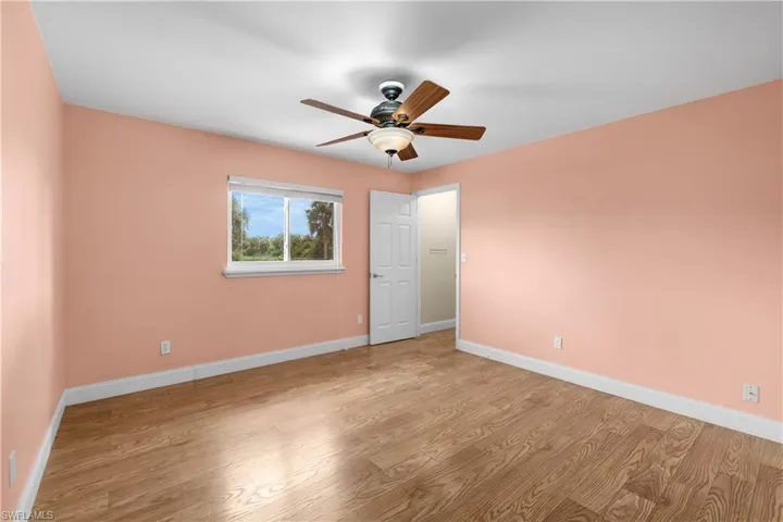 Unfurnished room featuring wood finished floors and ceiling fan