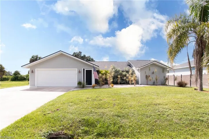 Ranch-style house featuring concrete driveway and a garage