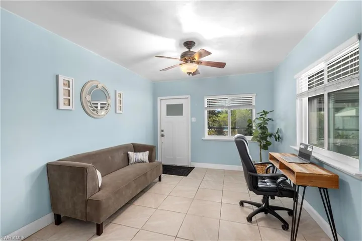 Home office featuring light tile patterned flooring and ceiling fan
