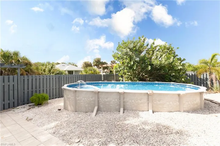 View of pool with a fenced backyard