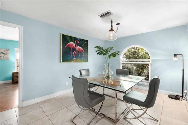 Dining space with light tile patterned floors