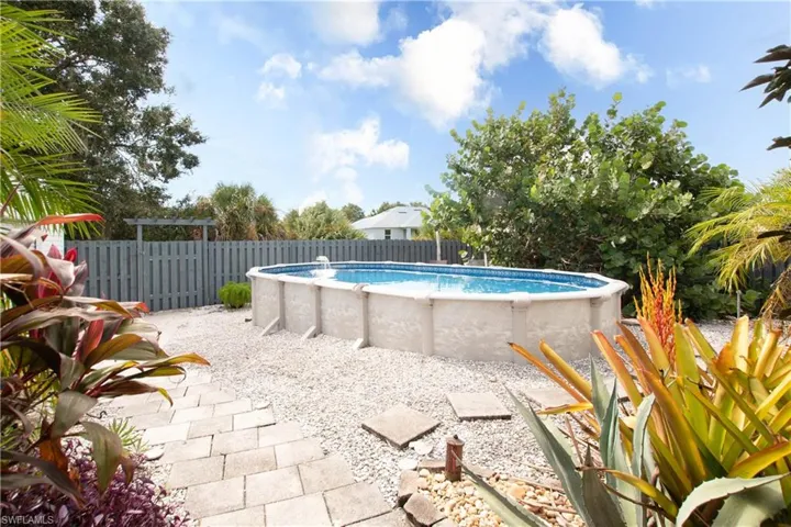 View of pool with a fenced backyard and a patio area