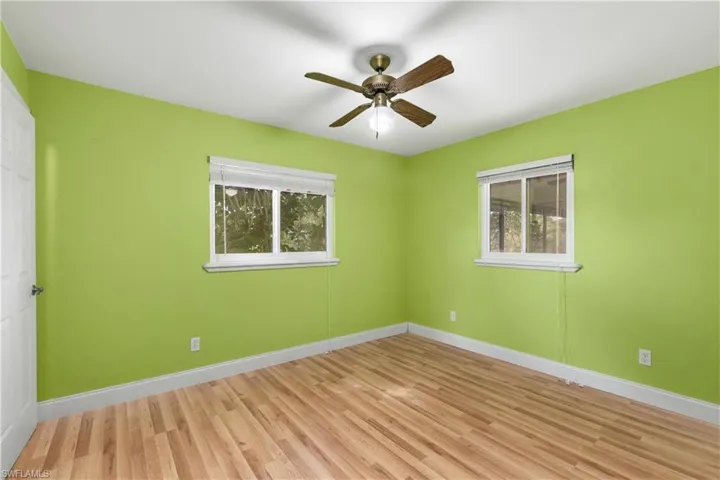 Unfurnished room with light wood finished floors and ceiling fan