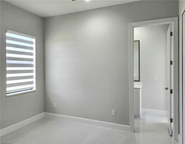 Tiled empty room featuring plenty of natural light