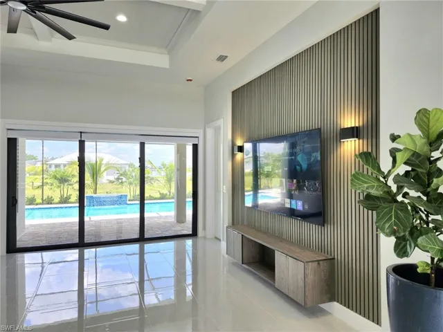 Tiled living room featuring ceiling fan and a healthy amount of sunlight